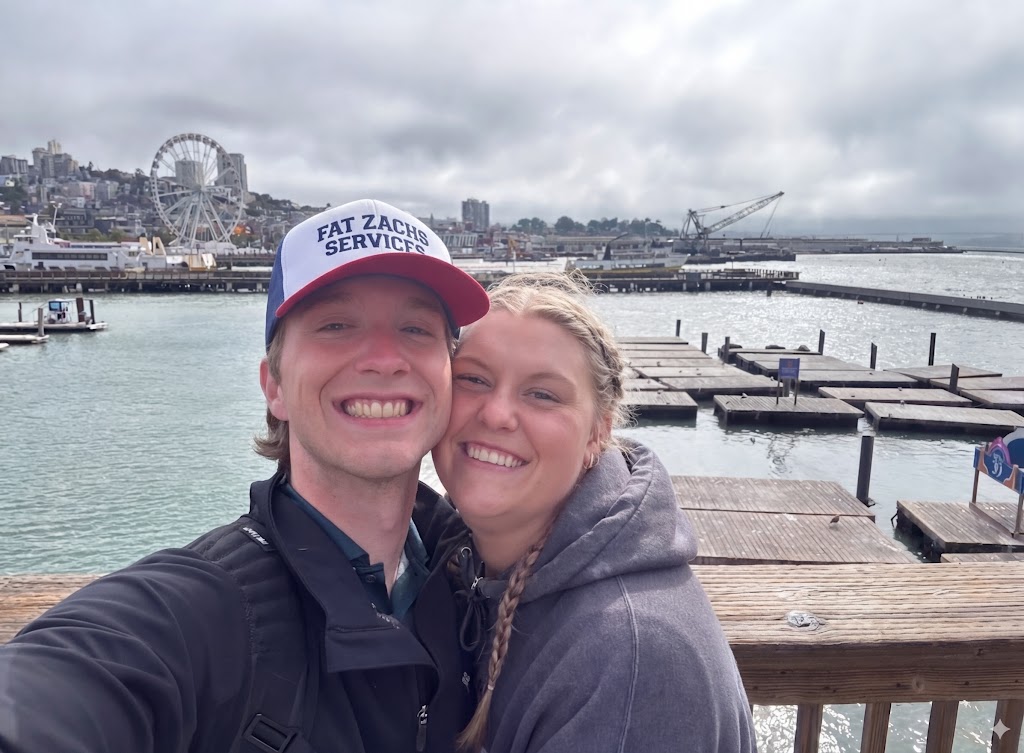 Mason and his wife in front of a harbor